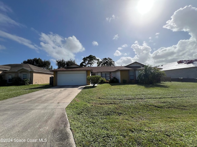 ranch-style home with a front lawn and a garage