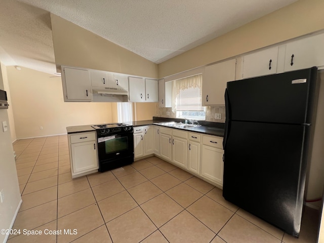 kitchen featuring a textured ceiling, white cabinets, black appliances, and vaulted ceiling