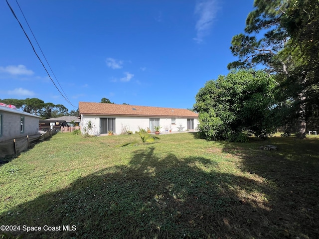 back of house with a yard