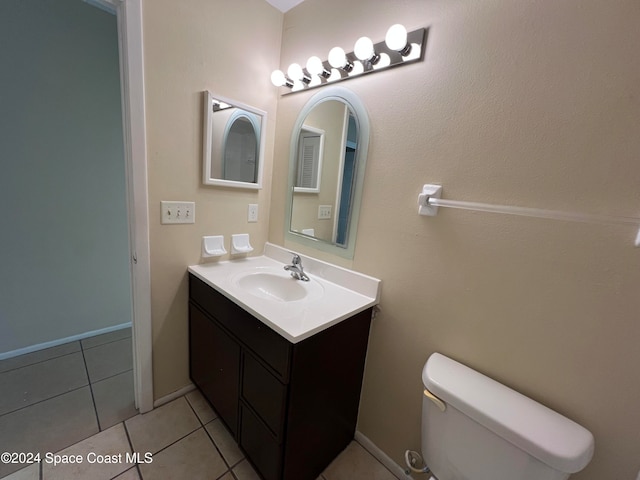 bathroom featuring tile patterned flooring, vanity, and toilet