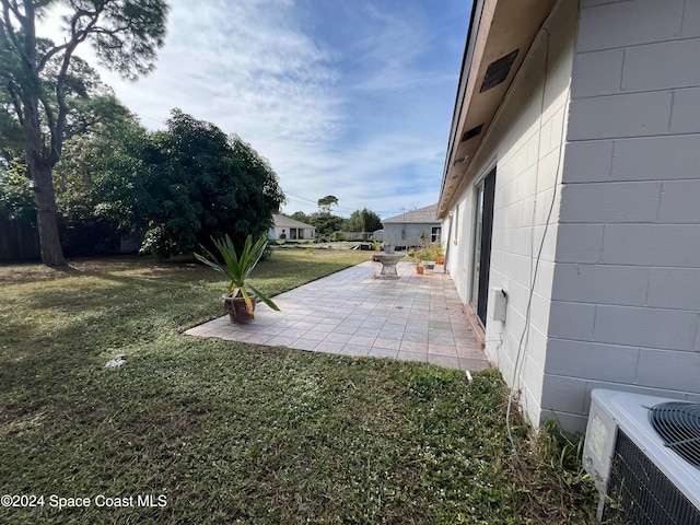 view of yard featuring cooling unit and a patio