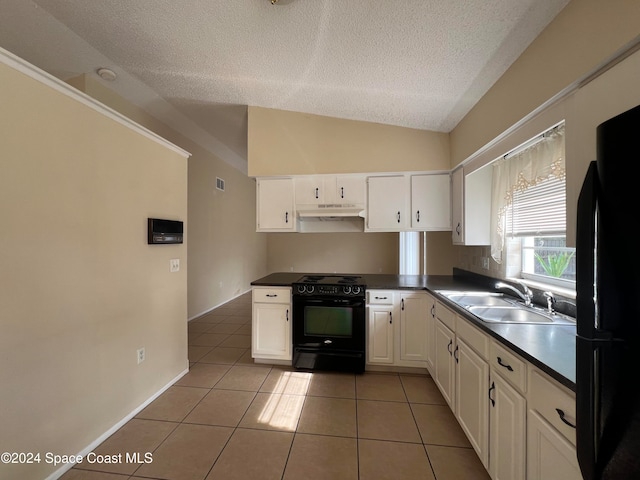 kitchen with tile patterned floors, white cabinetry, lofted ceiling, and black appliances