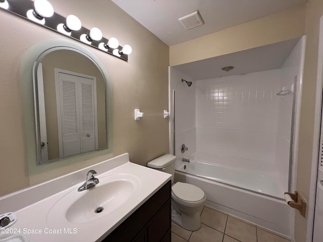 full bathroom featuring tile patterned flooring, vanity, tiled shower / bath combo, and toilet