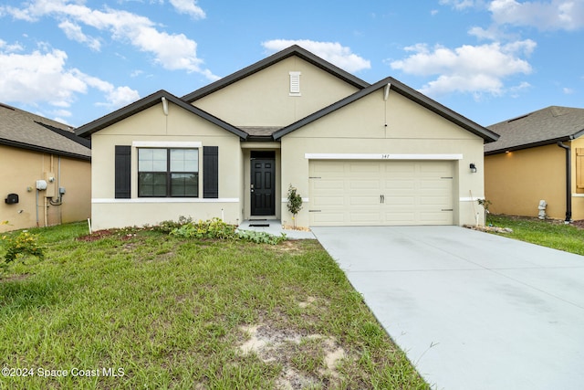 ranch-style home featuring a garage and a front lawn