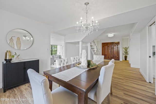 750 W Whitmire Dr, Melbourne, FL 32935 - dining area with a chandelier, light wood finished floors, stairway, and baseboards