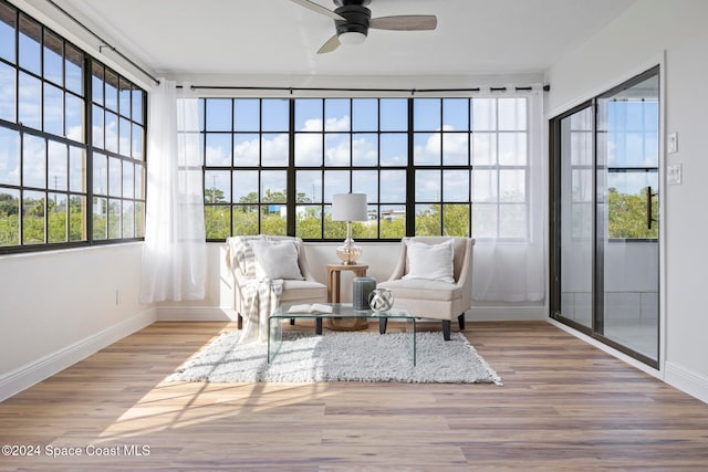 sunroom featuring ceiling fan