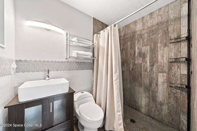 bathroom with a shower with curtain, toilet, tile walls, and sink