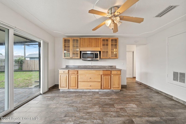 kitchen featuring ceiling fan and a textured ceiling