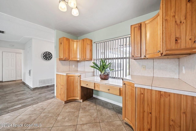 kitchen with backsplash and light tile patterned flooring