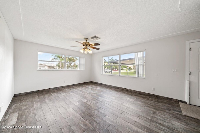 unfurnished room featuring a textured ceiling, dark hardwood / wood-style flooring, and ceiling fan