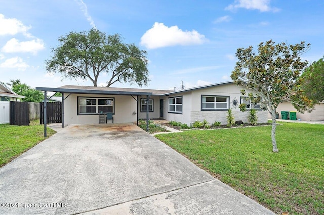 single story home with a front lawn and a carport