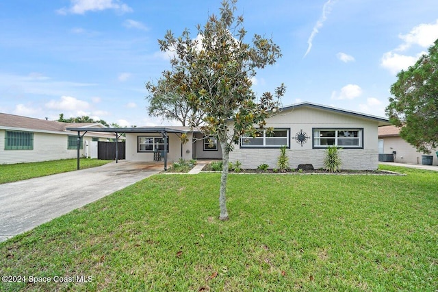 ranch-style home featuring a carport, central AC unit, and a front yard