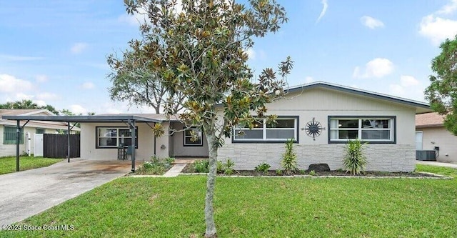 ranch-style home with a carport, a front lawn, and central AC