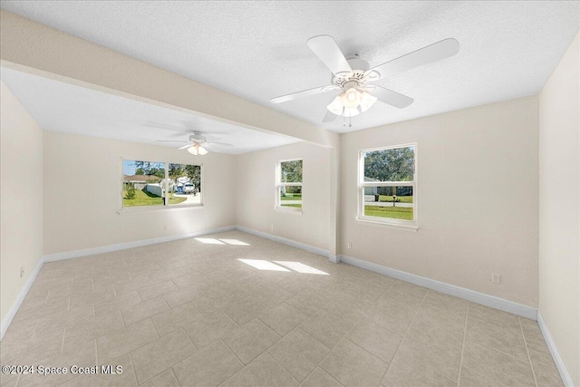 empty room featuring a textured ceiling and ceiling fan