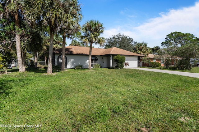 ranch-style home featuring a front lawn and a garage