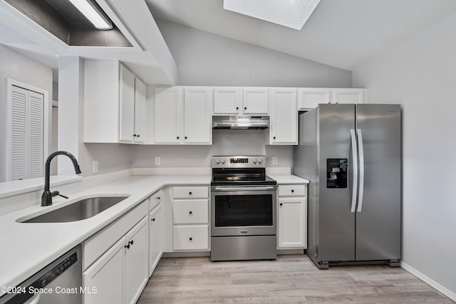 kitchen featuring light hardwood / wood-style flooring, stainless steel appliances, sink, lofted ceiling with skylight, and white cabinets