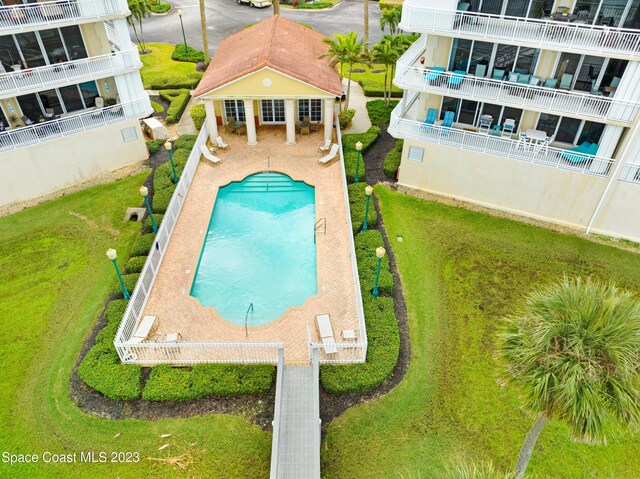 4975 Dixie Hwy NE Unit 201, Palm Bay, FL 32905 - view of pool with an exterior structure, an outdoor structure, a patio, and a lawn