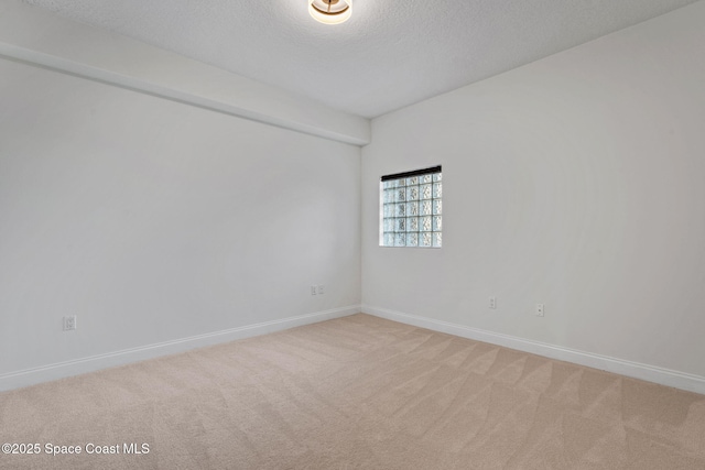 4975 Dixie Hwy NE Unit 201, Palm Bay, FL 32905 - spare room featuring light colored carpet, a textured ceiling, and baseboards
