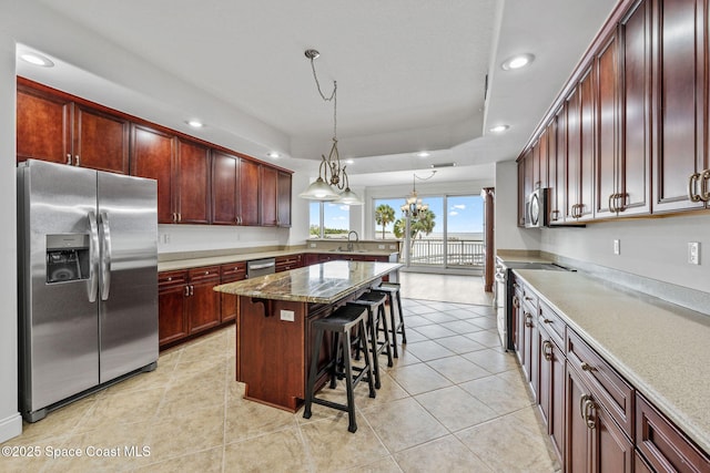 4975 Dixie Hwy NE Unit 201, Palm Bay, FL 32905 - kitchen with appliances with stainless steel finishes, a sink, recessed lighting, a kitchen bar, and light tile patterned flooring