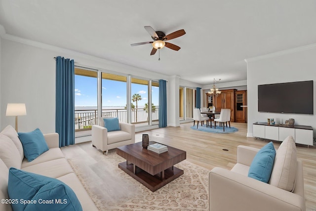4975 Dixie Hwy NE Unit 201, Palm Bay, FL 32905 - living room featuring a chandelier, ceiling fan, light wood-style flooring, and crown molding