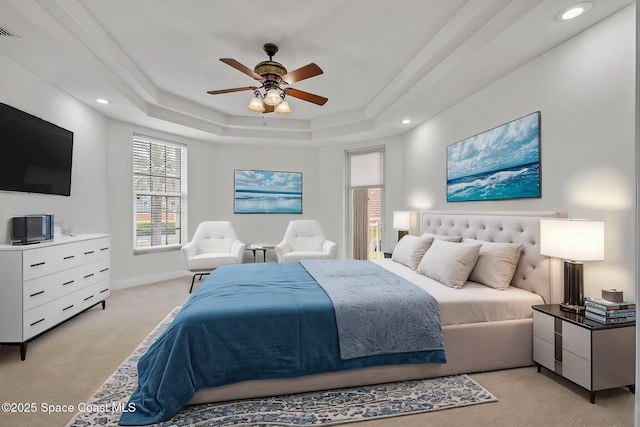 4975 Dixie Hwy NE Unit 201, Palm Bay, FL 32905 - bedroom with light carpet, a tray ceiling, recessed lighting, ceiling fan, and baseboards
