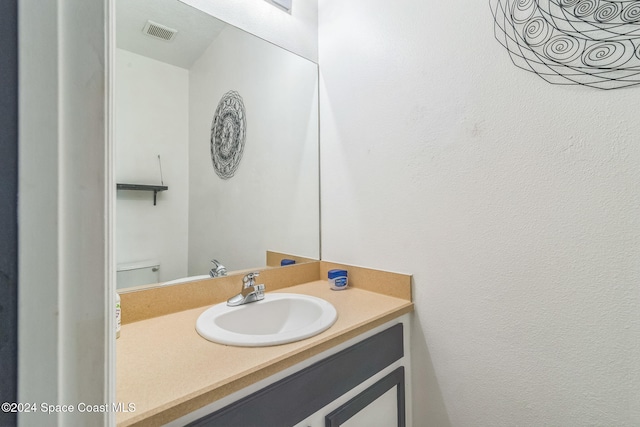 bathroom with toilet and vanity