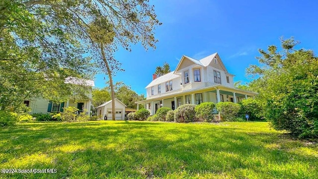 view of front of house with a front yard and covered porch