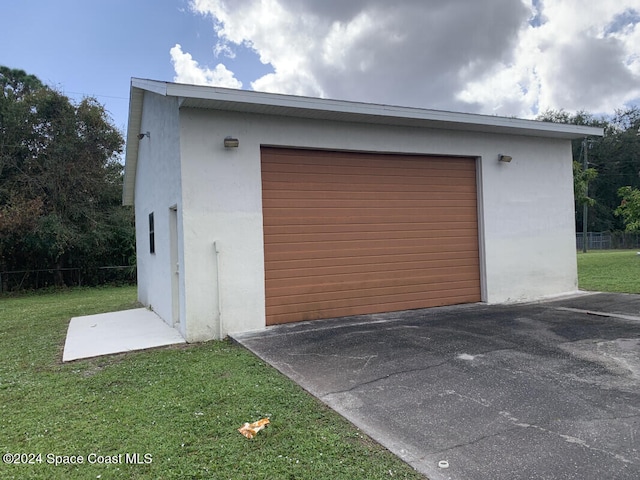 garage featuring a yard