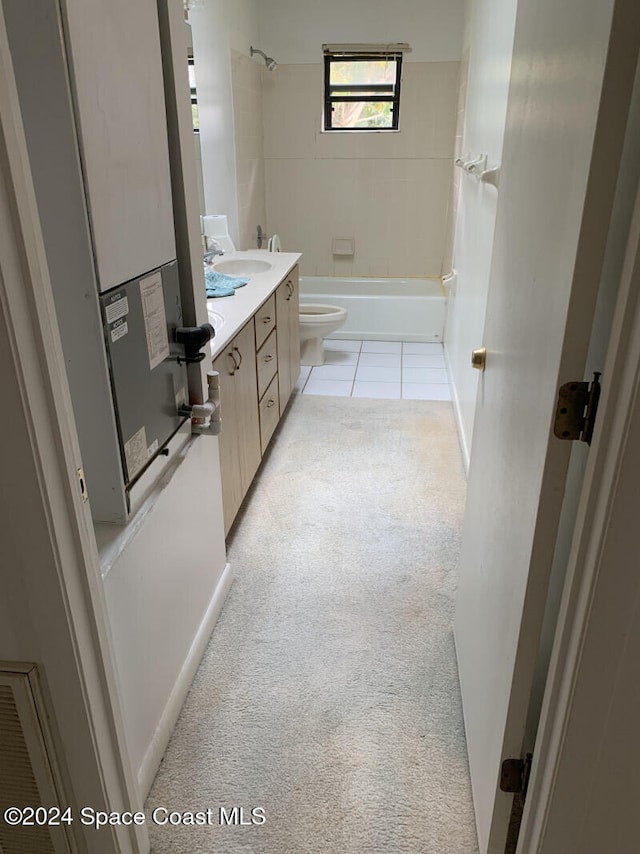 full bathroom featuring toilet, tiled shower / bath combo, vanity, and tile patterned floors