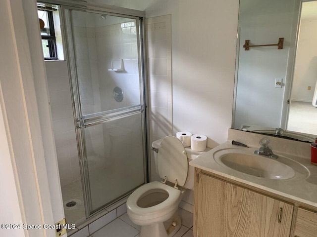 bathroom featuring vanity, walk in shower, toilet, and tile patterned floors