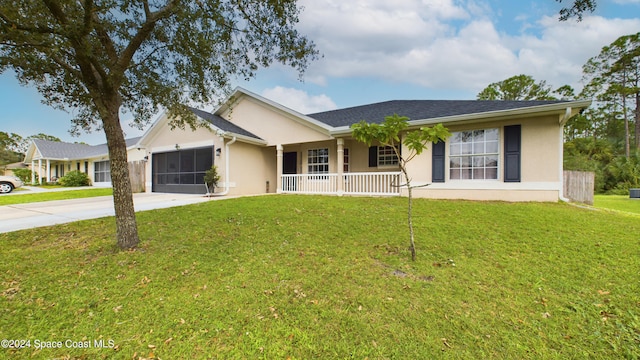 ranch-style house with a front yard, covered porch, and a garage