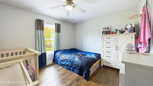 bedroom with dark hardwood / wood-style floors and ceiling fan