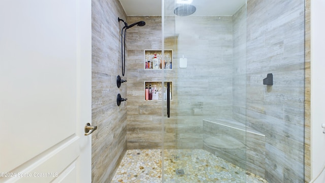 bathroom featuring a shower with shower door