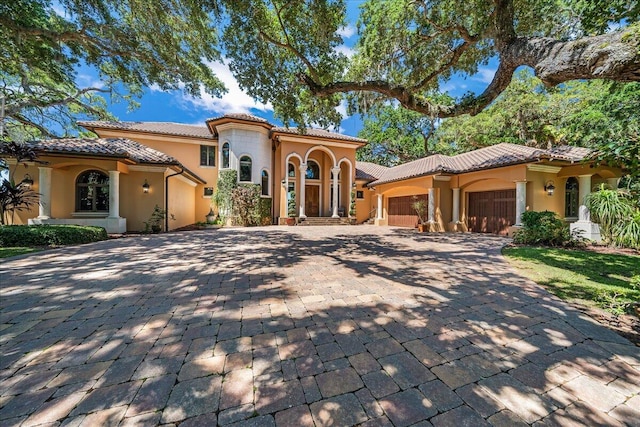 mediterranean / spanish-style house featuring a garage