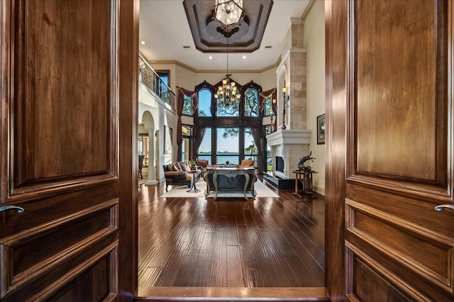 interior space featuring a notable chandelier, hardwood / wood-style flooring, and crown molding