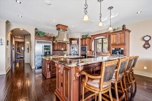 808 N Riverside Dr, Indialantic, FL 32903 - kitchen featuring a large island, arched walkways, baseboards, built in appliances, and recessed lighting