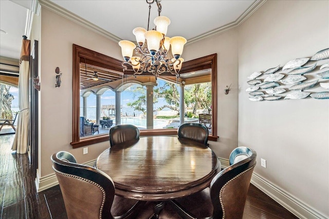 dining room with a notable chandelier, dark wood-type flooring, and crown molding