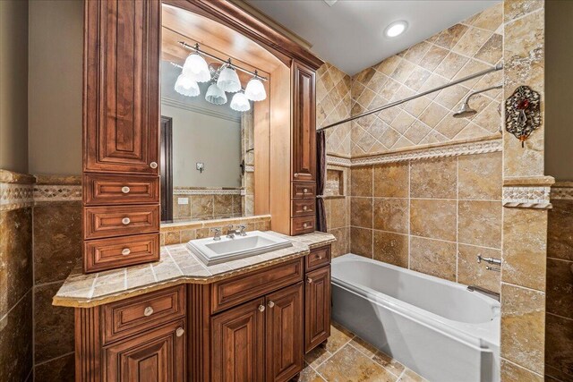 808 N Riverside Dr, Indialantic, FL 32903 - bathroom featuring tile walls, vanity,  shower combination, and recessed lighting