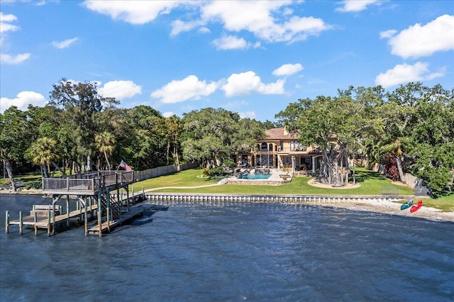 exterior space with a yard, a pool, and a water view