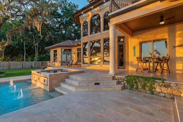 view of swimming pool featuring an in ground hot tub, pool water feature, and a patio area