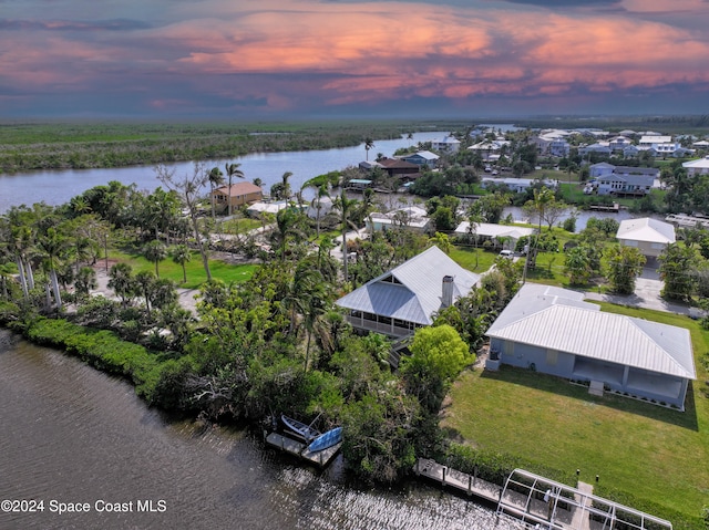 aerial view at dusk with a water view