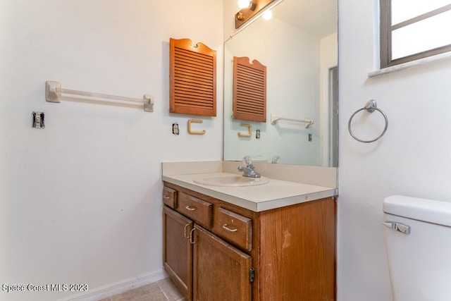 bathroom with tile patterned flooring, vanity, and toilet