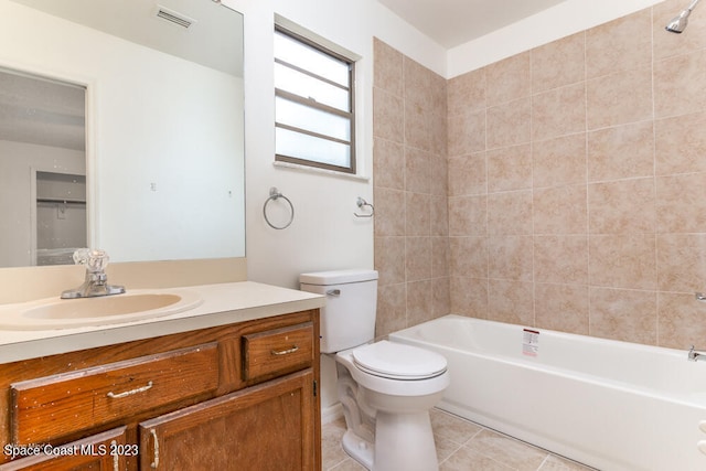 full bathroom featuring tile patterned floors, vanity, toilet, and tiled shower / bath