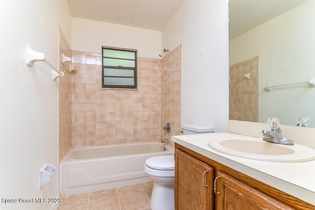 full bathroom featuring tile patterned flooring, vanity, toilet, and tiled shower / bath