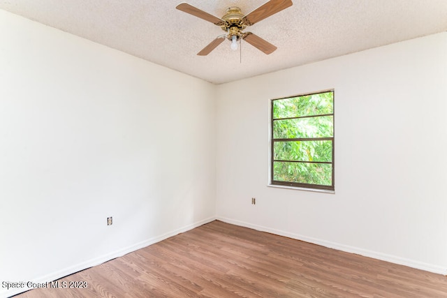 unfurnished room with hardwood / wood-style floors, ceiling fan, and a textured ceiling