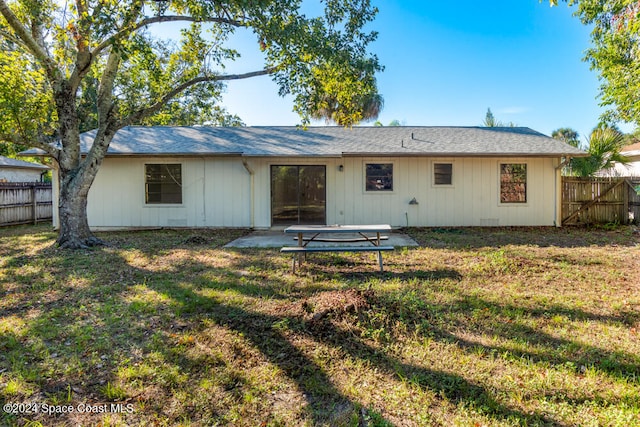 rear view of property featuring a yard