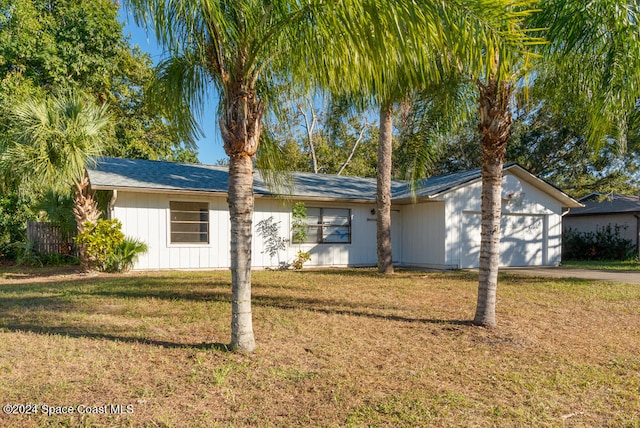 single story home with a front lawn and a garage