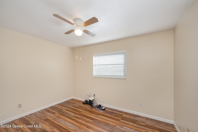 empty room with ceiling fan and wood-type flooring