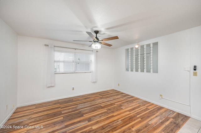 spare room with hardwood / wood-style flooring and ceiling fan