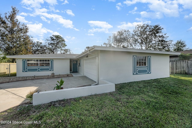 single story home with a garage and a front yard